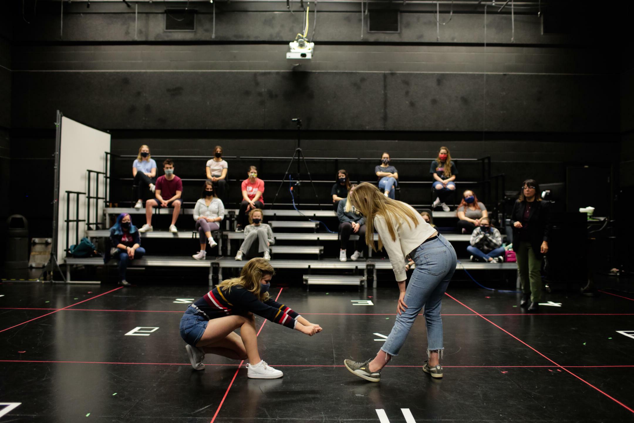 Students practicing in a blackbox theatre