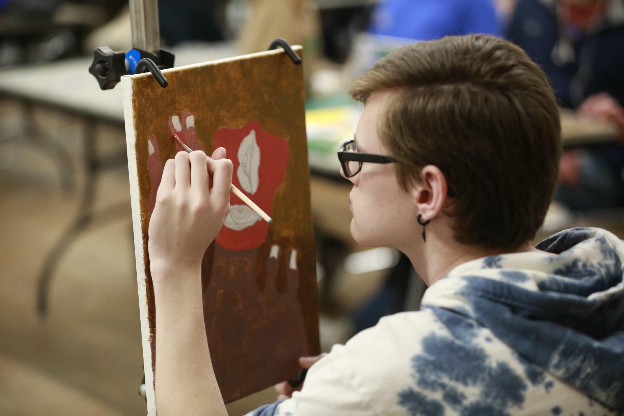 Student painting on a canvas
